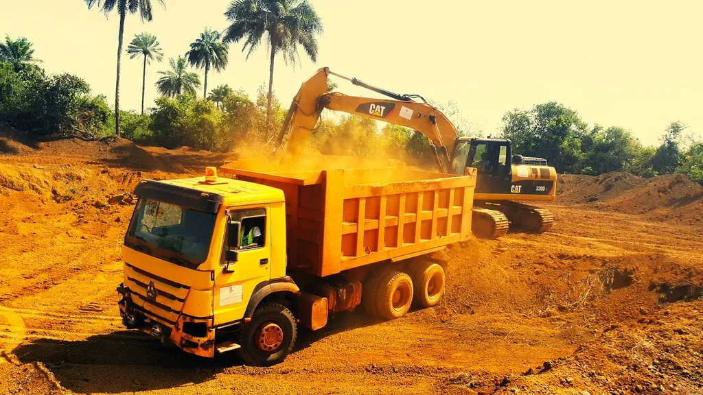 LinCon dumper truck being loaded by an excavator on a mining haul road in Sierra Leone