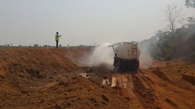 Water bowser spraying a road formation during construction