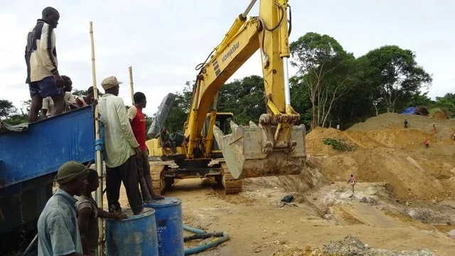 Excavator and site crew during works near a water course