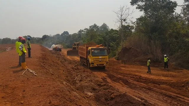Feeder road construction with tipper trucks and surveyors